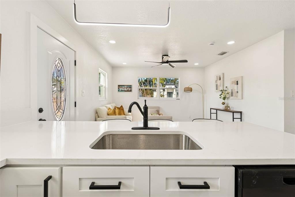 7097 Delta Way Clearwater, FL 33764 - Photo 28 of 71 a kitchen with a sink a counter space and cabinets