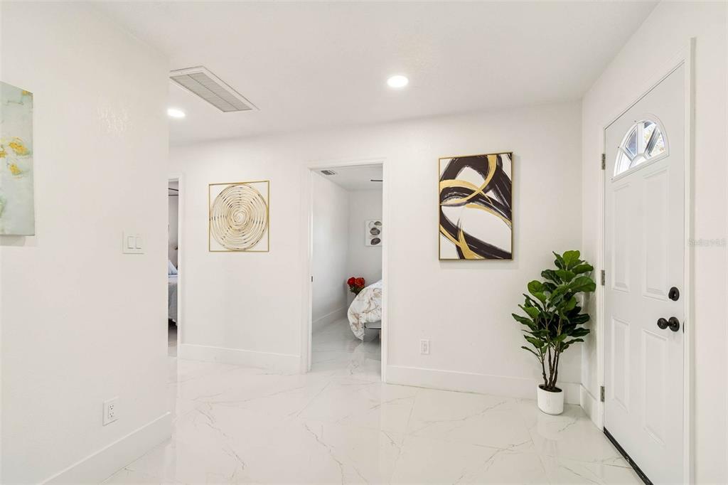 7097 Delta Way Clearwater, FL 33764 - Photo 31 of 71 a view of a hallway with paintings on the wall
