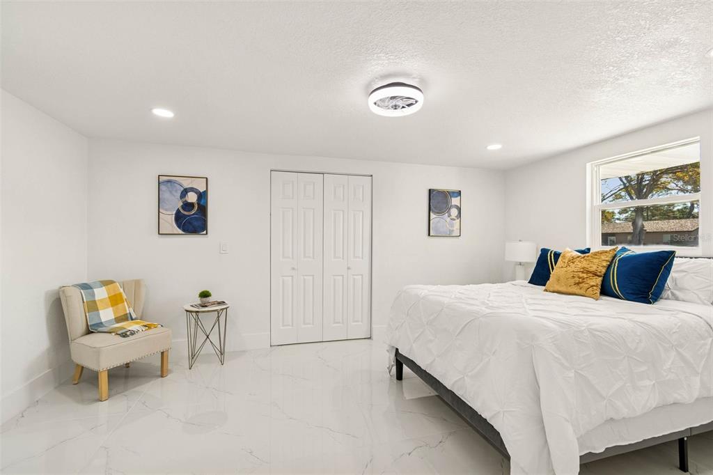 7097 Delta Way Clearwater, FL 33764 - Photo 32 of 71 a bedroom with a bed and a couch