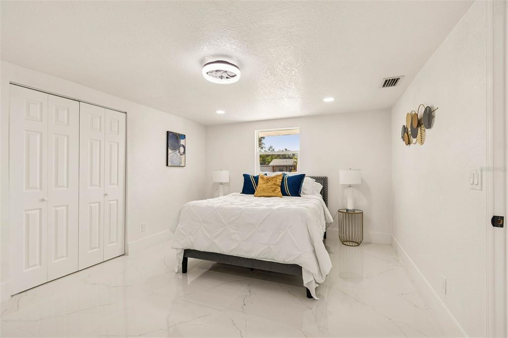 7097 Delta Way Clearwater, FL 33764 - Photo 33 of 71 a spacious bedroom with a bed and a window