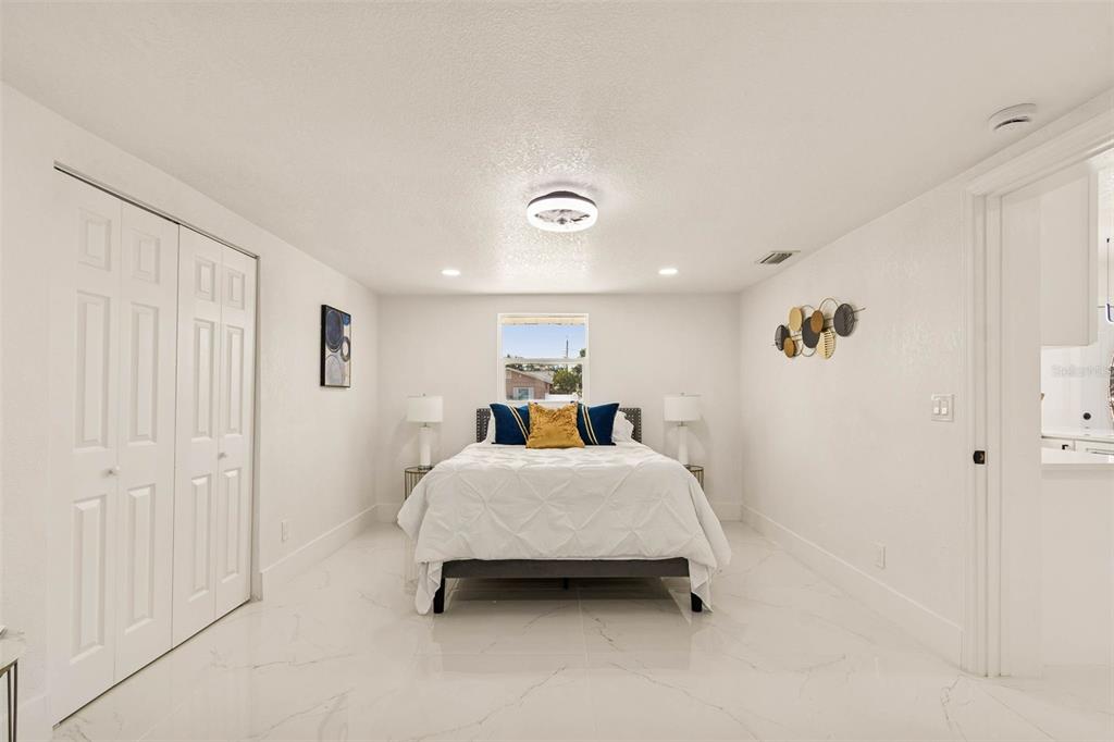 7097 Delta Way Clearwater, FL 33764 - Photo 34 of 71 a room with a bed and a chandelier