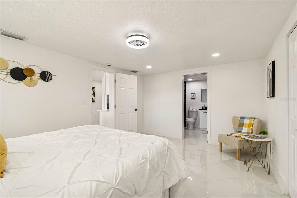 7097 Delta Way Clearwater, FL 33764 - Photo 36 of 71 a bedroom with a bed and a couch