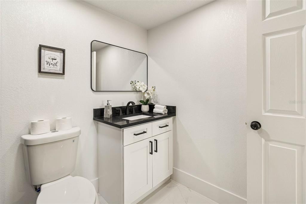 7097 Delta Way Clearwater, FL 33764 - Photo 38 of 71 a bathroom with a granite countertop toilet sink and mirror