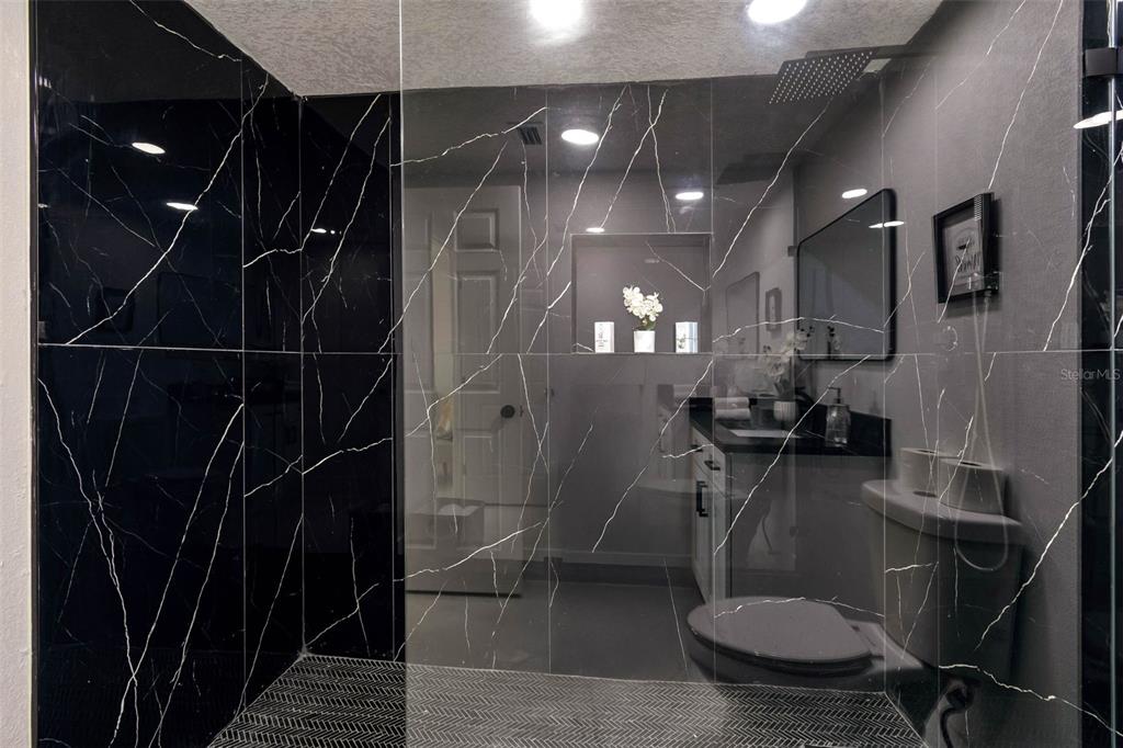 7097 Delta Way Clearwater, FL 33764 - Photo 39 of 71 a bathroom with a toilet a sink and view kitchen