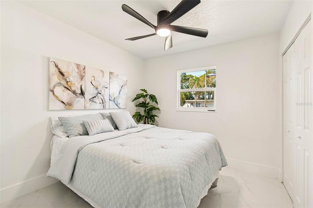 7097 Delta Way Clearwater, FL 33764 - Photo 40 of 71 a bedroom with a large bed and a painting on the wall