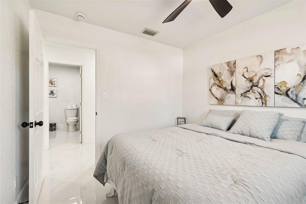 7097 Delta Way Clearwater, FL 33764 - Photo 41 of 71 a bedroom with a bed and a painting on the wall