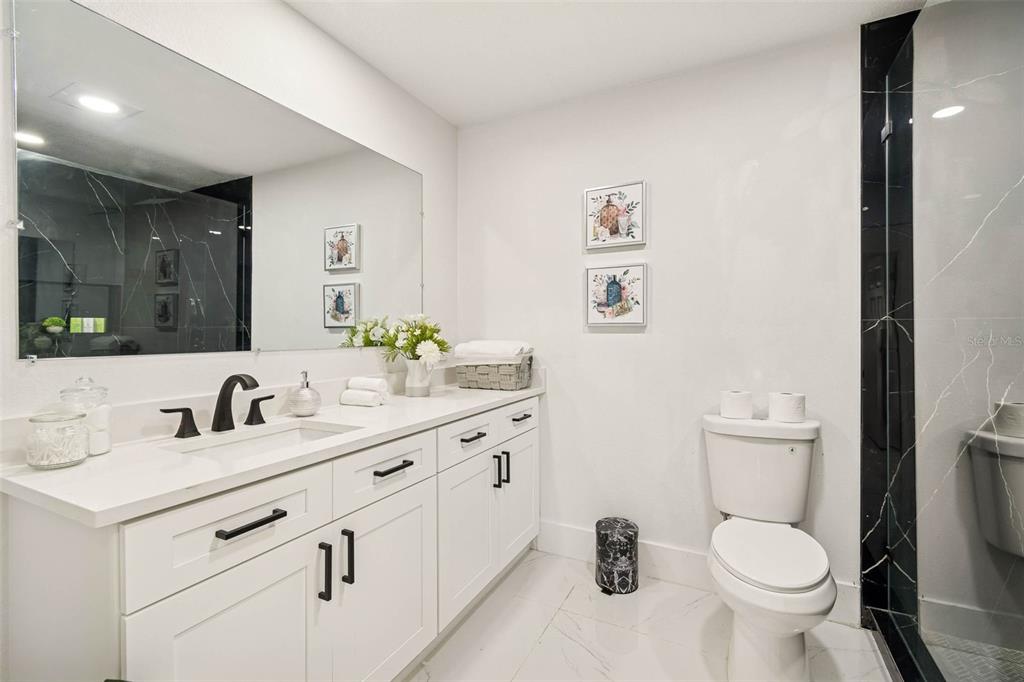 7097 Delta Way Clearwater, FL 33764 - Photo 42 of 71 a bathroom with a toilet sink and mirror