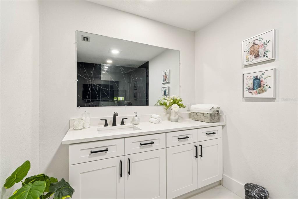 7097 Delta Way Clearwater, FL 33764 - Photo 44 of 71 a bathroom with a sink and a mirror