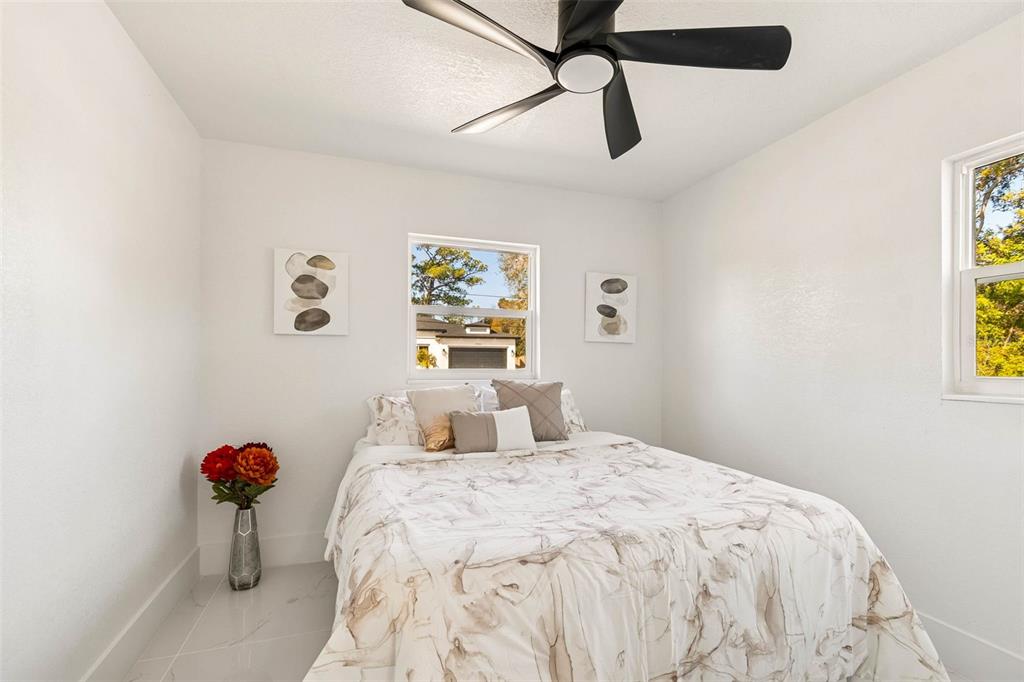 7097 Delta Way Clearwater, FL 33764 - Photo 45 of 71 a bedroom with a bed and a chandelier