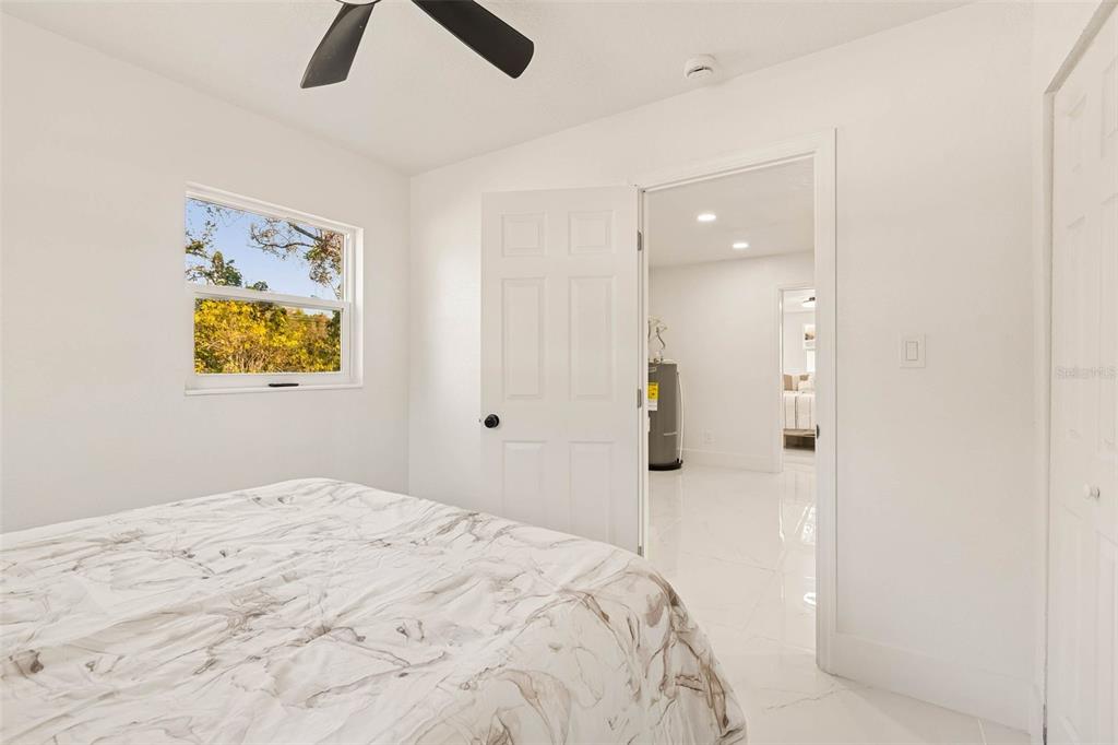 7097 Delta Way Clearwater, FL 33764 - Photo 46 of 71 a bedroom with a bed and painting on the wall