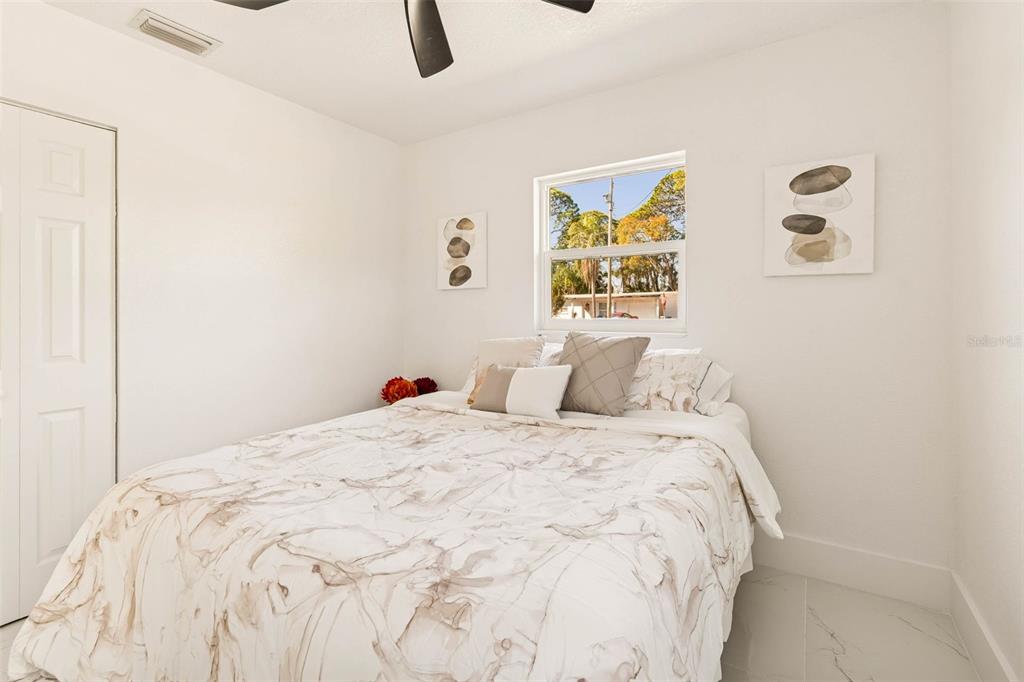 7097 Delta Way Clearwater, FL 33764 - Photo 47 of 71 a bedroom with a bed and painting on the wall