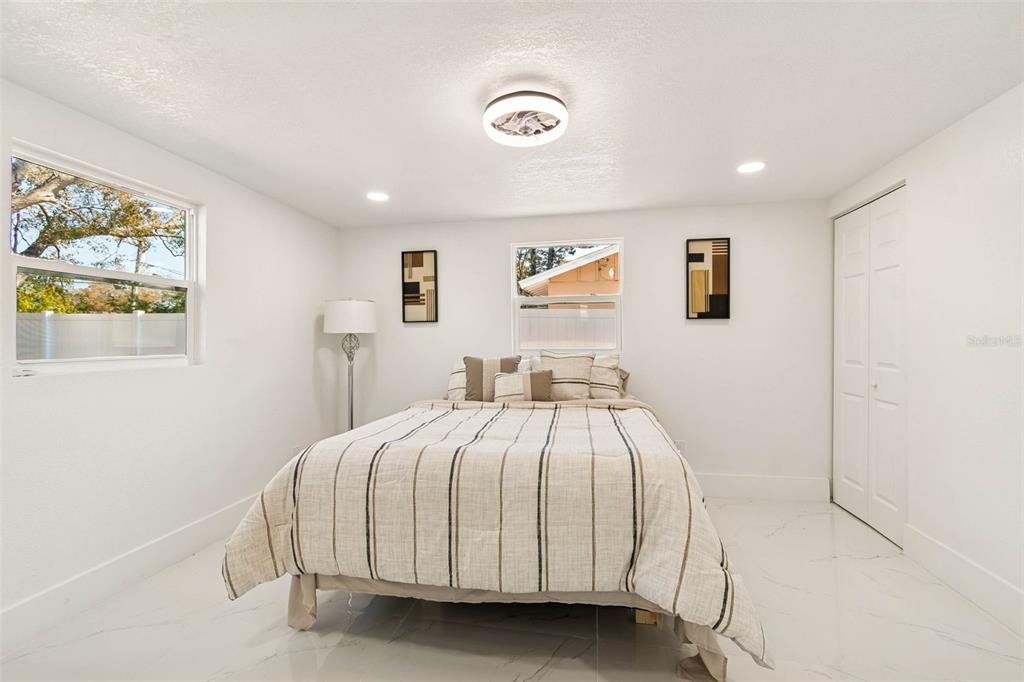 7097 Delta Way Clearwater, FL 33764 - Photo 48 of 71 a bedroom with a bed and painting on the wall