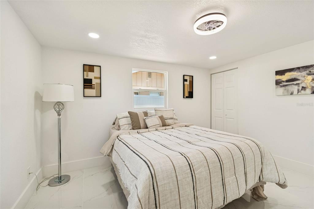 7097 Delta Way Clearwater, FL 33764 - Photo 49 of 71 a bedroom with a bed and painting on the wall