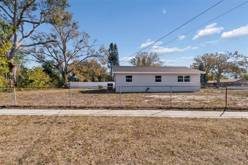 7097 Delta Way Clearwater, FL 33764 - Photo 8 of 71 a front view of a house with a yard