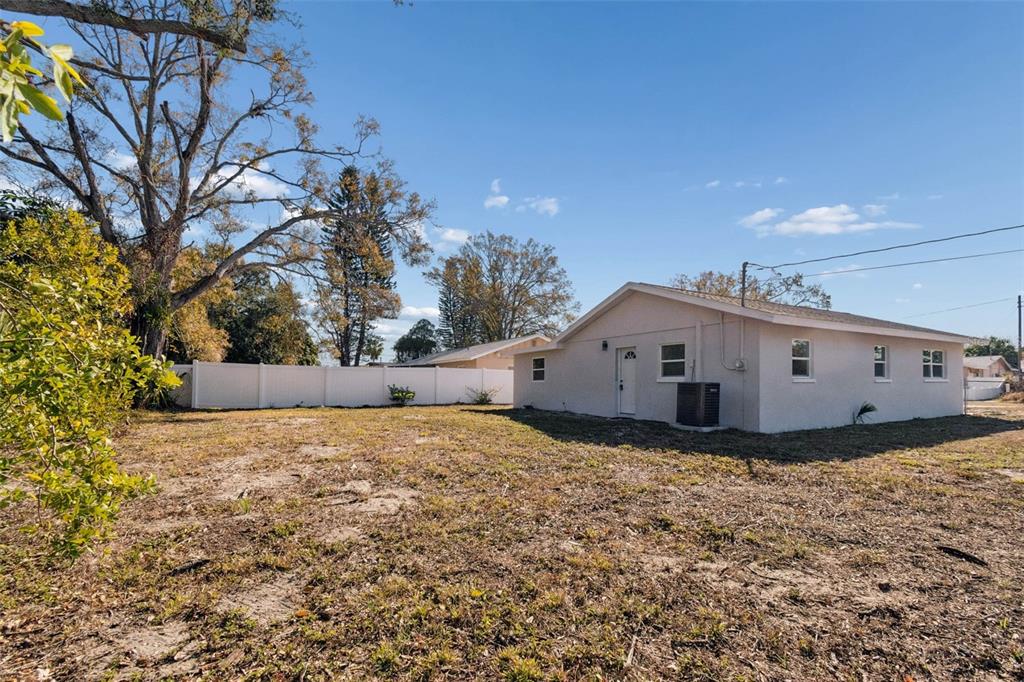 7097 Delta Way Clearwater, FL 33764 - Photo 10 of 71 a view of a house with a yard and large trees