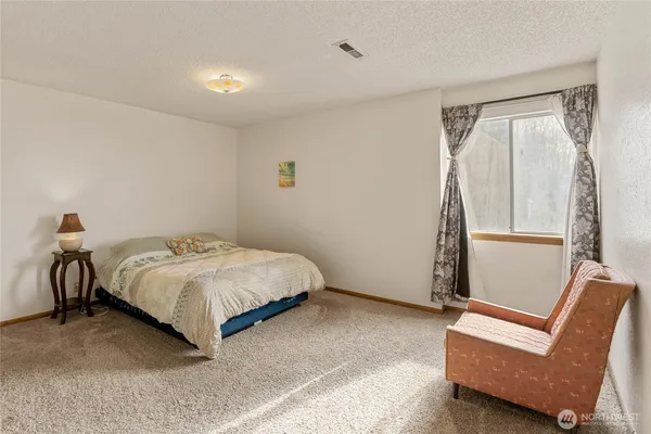 a bedroom with a bed and a couch