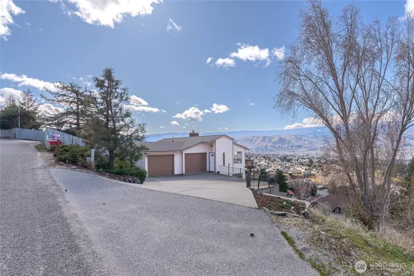 a view of a house with a yard and pathway
