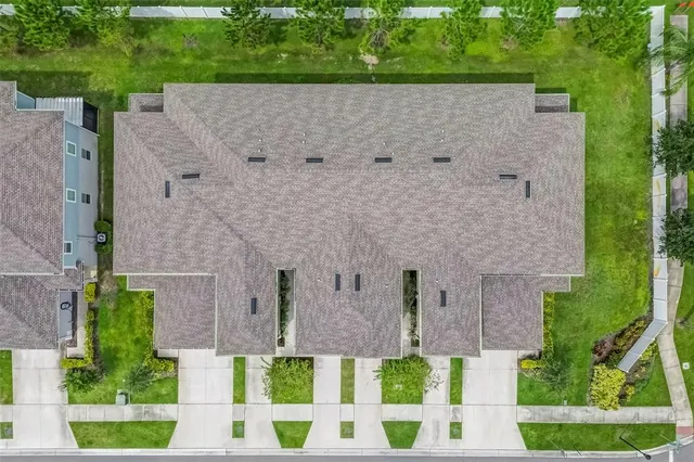 aerial view of a house with a yard and plants