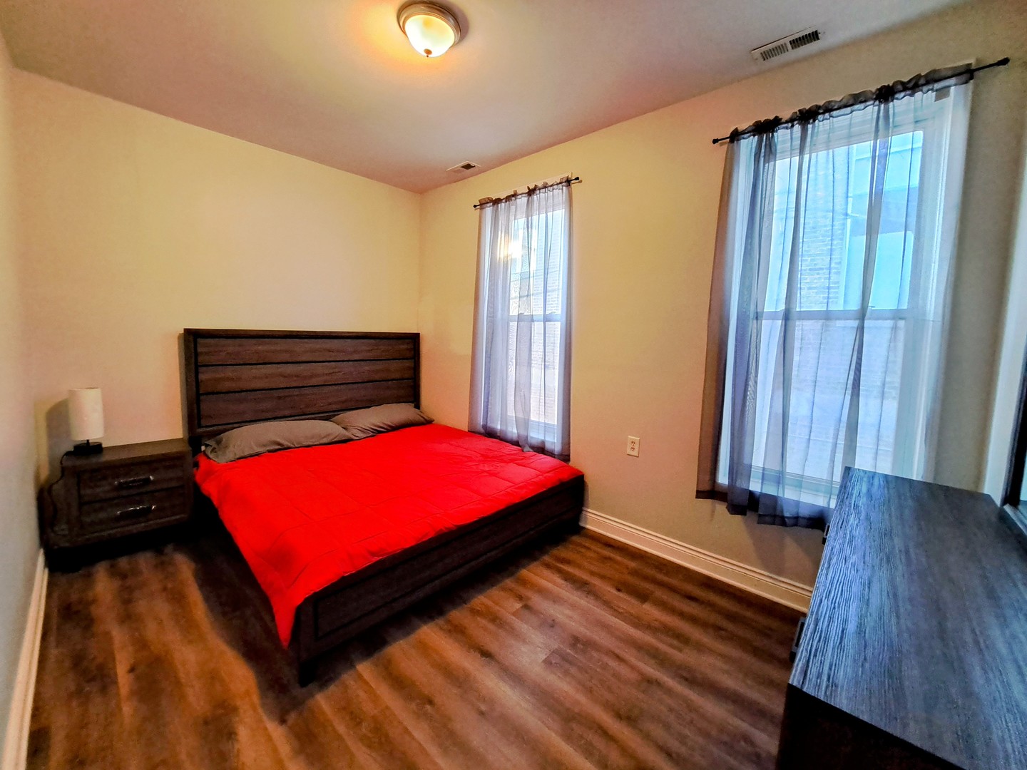 1540 West 17th Street, Unit 2 Chicago, IL 60608 - Photo 10 of 22 a bedroom with a bed and wooden floor