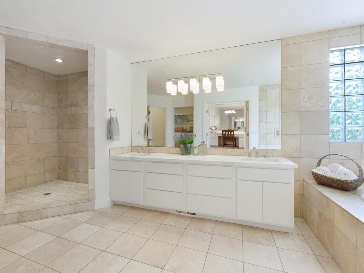 2433 H Road Grand Junction, CO 81505 - Photo 22 of 42 a bathroom with a sink a large mirror and a shower