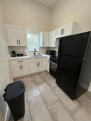 a bathroom with a sink a toilet a mirror and shower