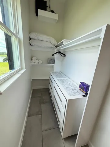 a view of livingroom and closet with wooden floor