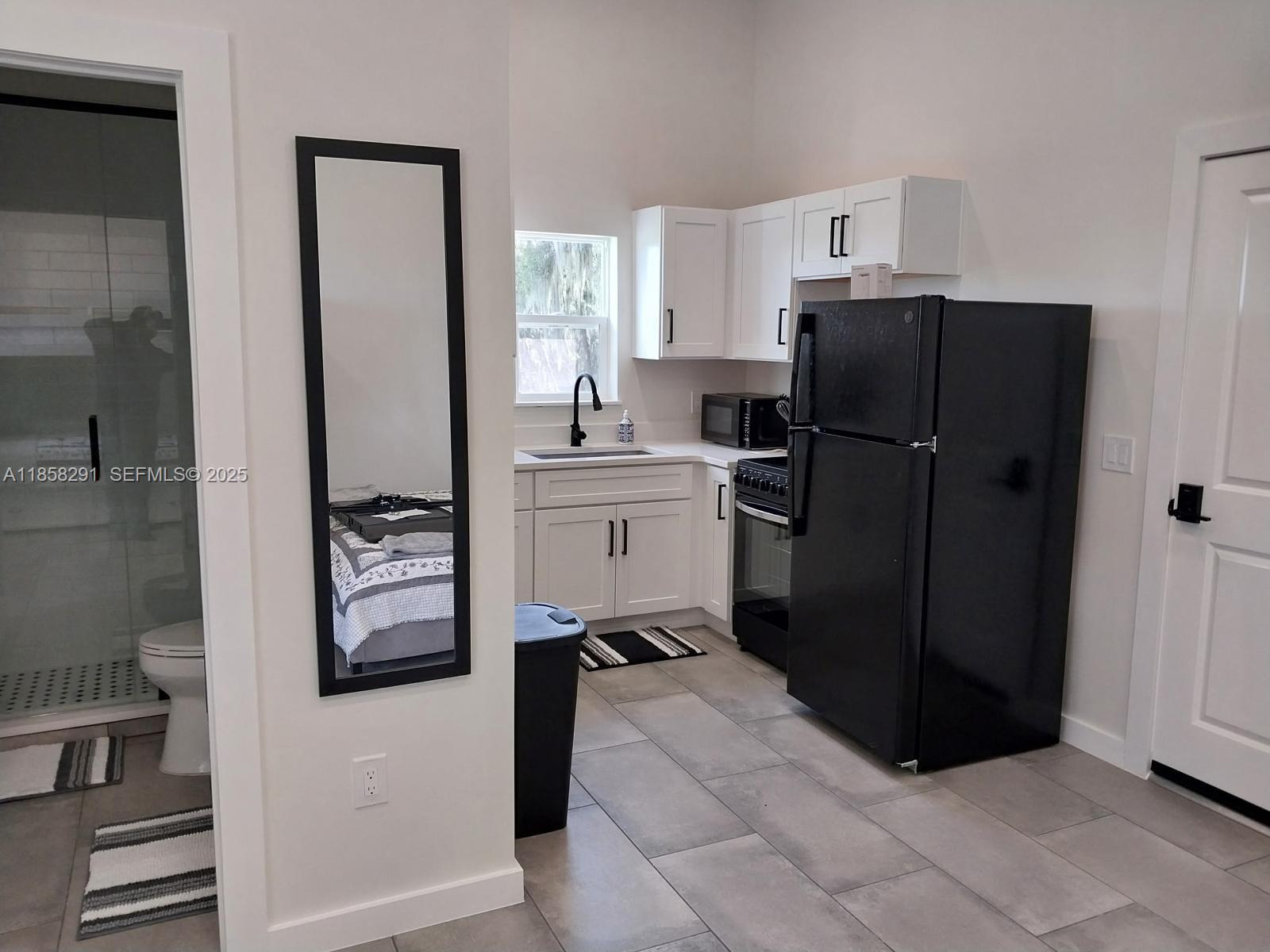 20925 Northwest 100th Avenue Road Micanopy, FL 32667 - Photo 10 of 19 a kitchen with a refrigerator and a stove