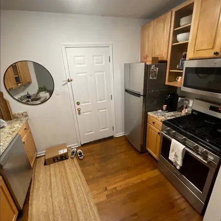 a kitchen with a refrigerator and a stove