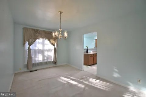 a view of a room with a chandelier swimming pool and windows