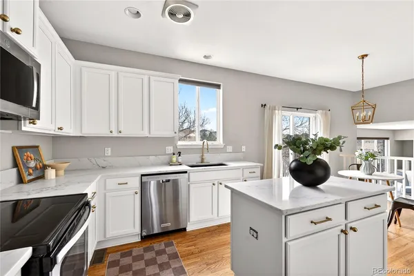a kitchen with a sink stove and microwave