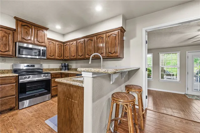 a kitchen with stainless steel appliances granite countertop a stove and a sink