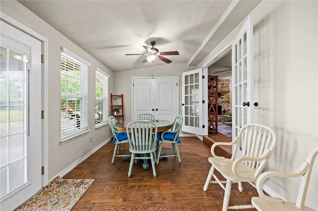 a dining room with furniture a rug and wooden floor