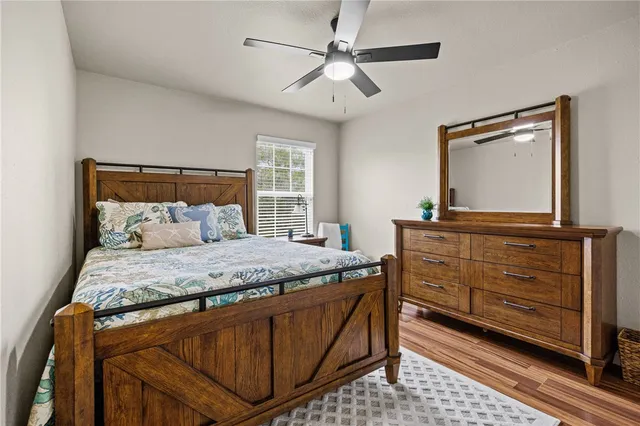 a bedroom with a bed and a mirror on dresser