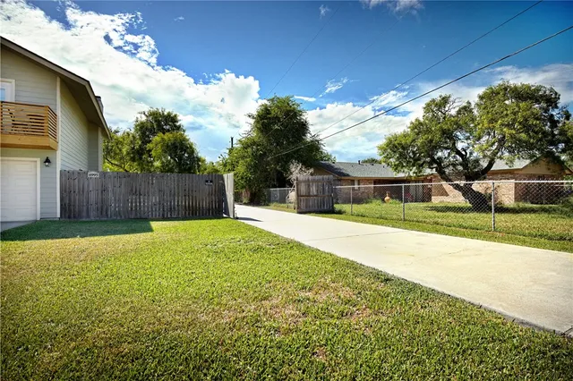 a view of a house with a backyard