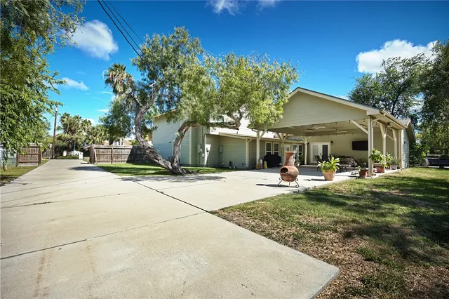 a view of a house with backyard porch and sitting area