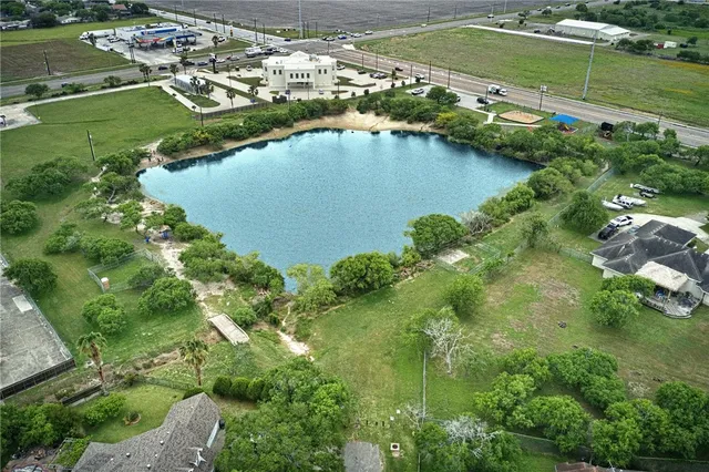an aerial view of a houses with outdoor space and lake view