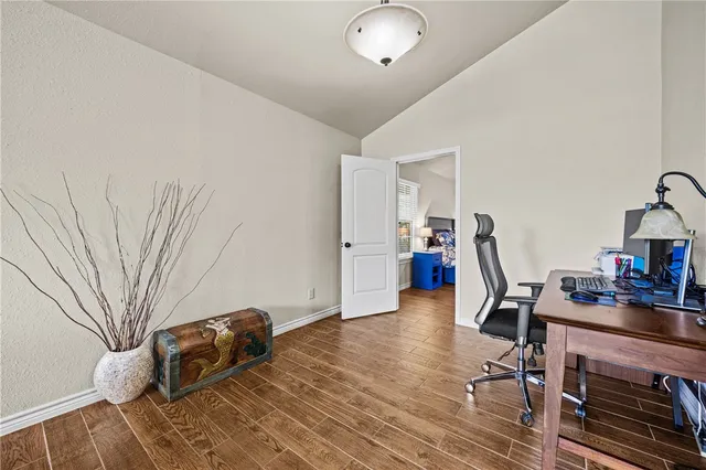 a bedroom with furniture and a wooden floor