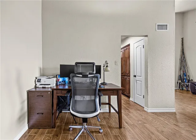 a workspace with furniture and wooden floor