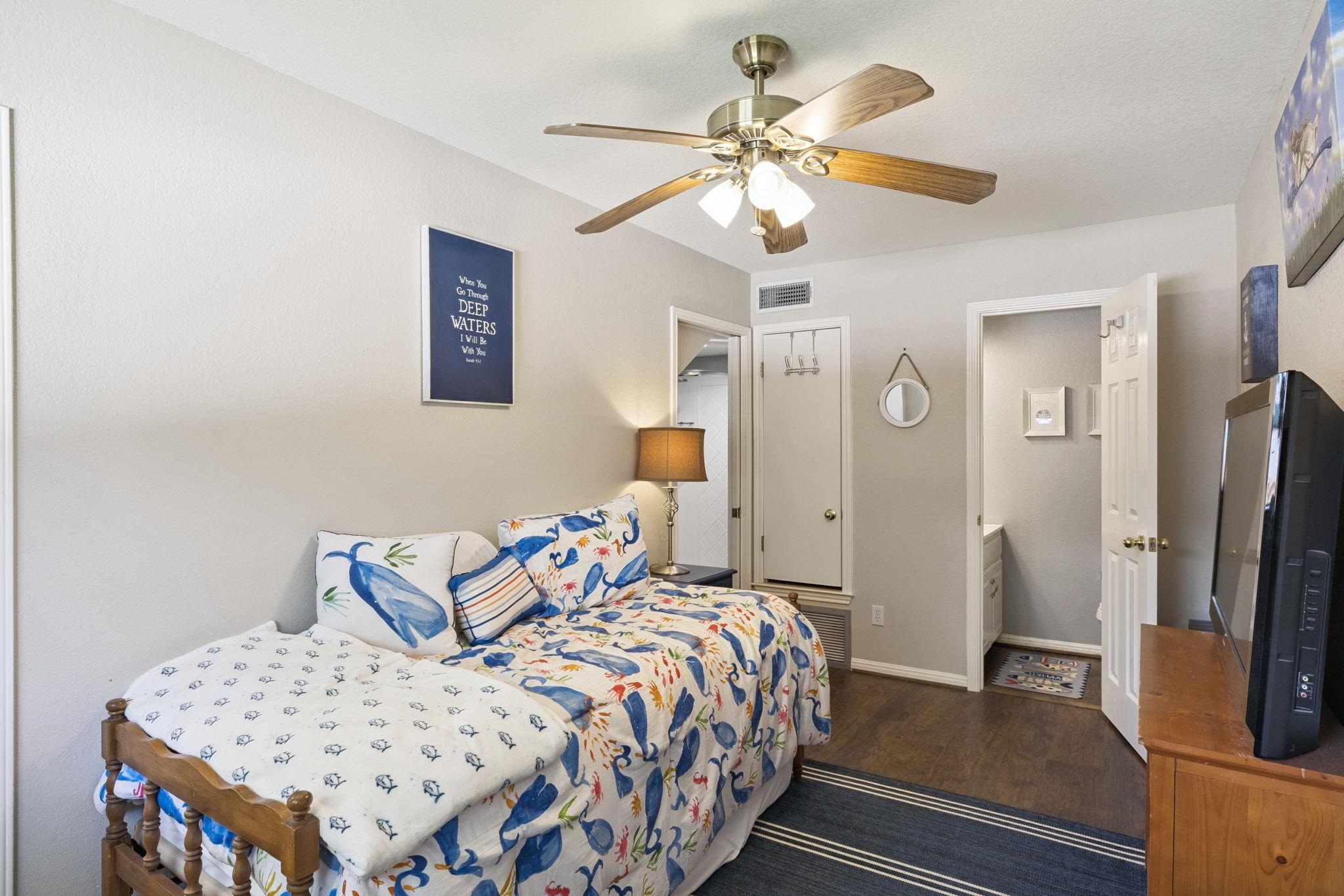 1435 East Zipp Road New Braunfels, TX 78130 - Photo 29 of 43 a bedroom with a bed and a chandelier
