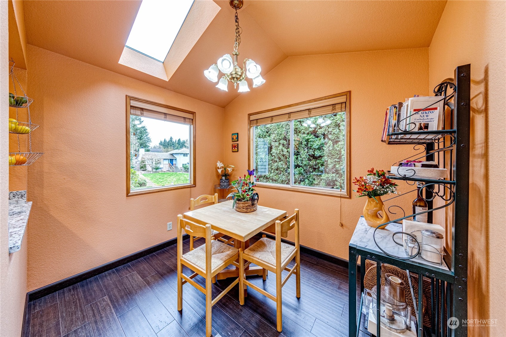 3213 211th Street Southeast Bothell, WA 98021 - Photo 14 of 33 a dining room with furniture a chandelier and wooden floor