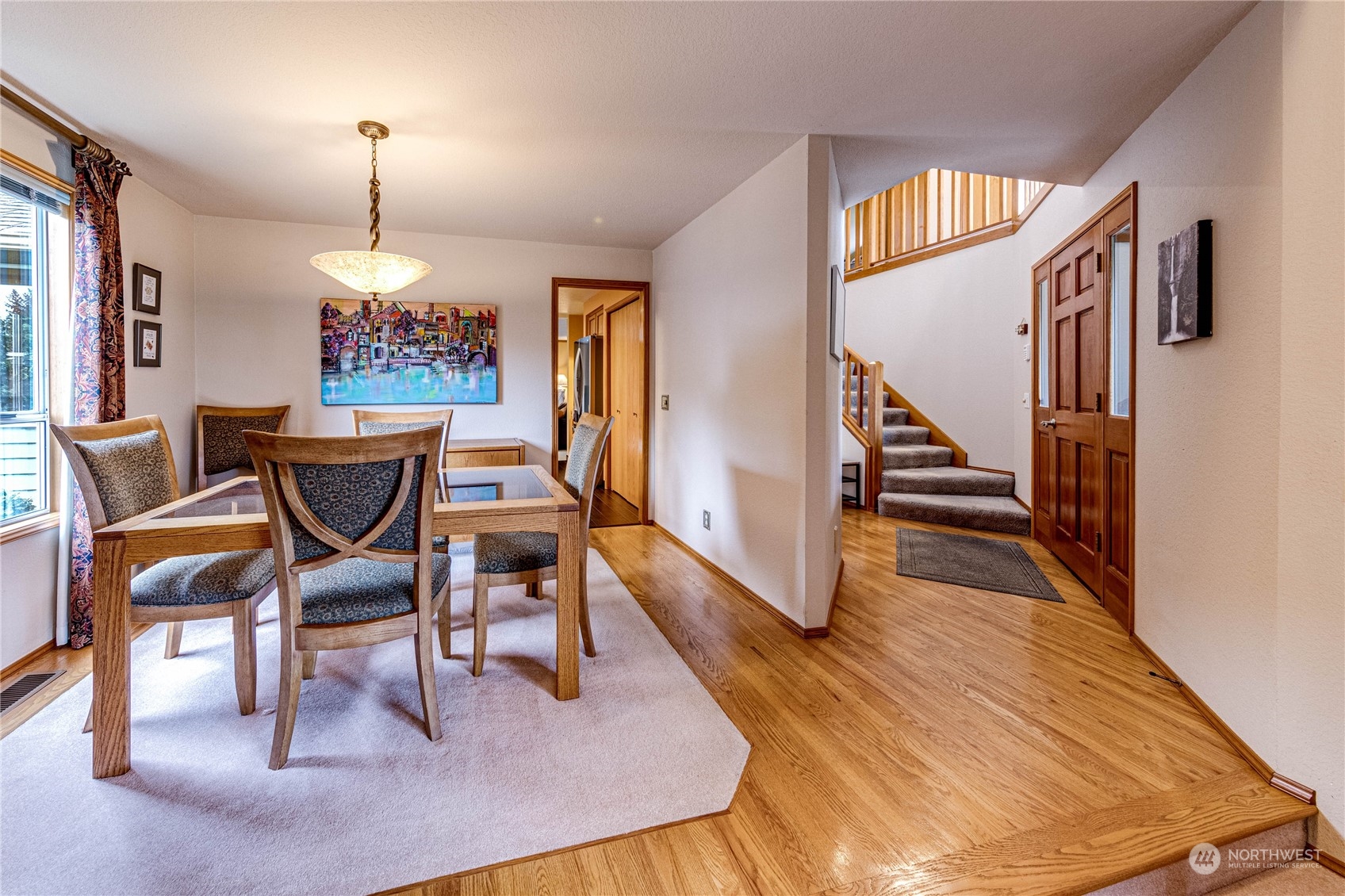 3213 211th Street Southeast Bothell, WA 98021 - Photo 5 of 33 a dining room with furniture a chandelier and wooden floor
