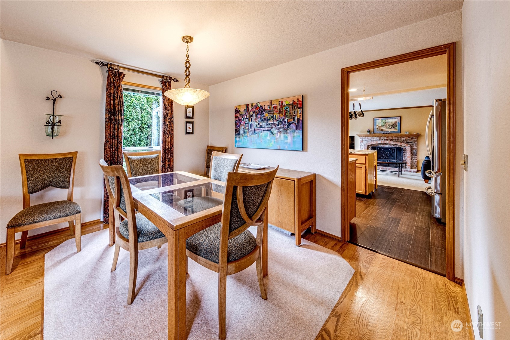 3213 211th Street Southeast Bothell, WA 98021 - Photo 6 of 33 a dining room with furniture a chandelier and wooden floor