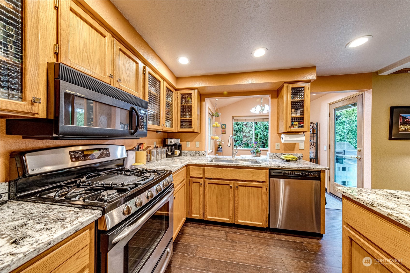 3213 211th Street Southeast Bothell, WA 98021 - Photo 10 of 33 a kitchen with stainless steel appliances granite countertop a stove and a sink