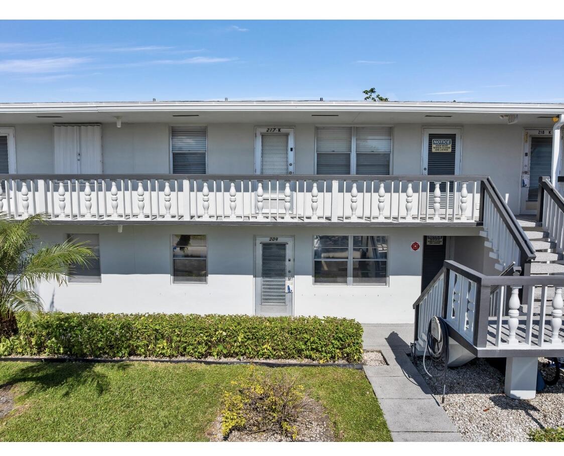 209 Northampton K, Unit K West Palm Beach, FL 33417 - Photo 24 of 24 a front view of a house with a yard