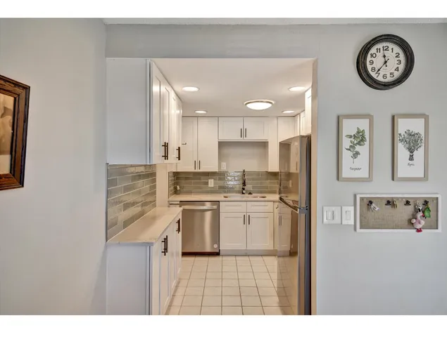 a kitchen with cabinets and stainless steel appliances