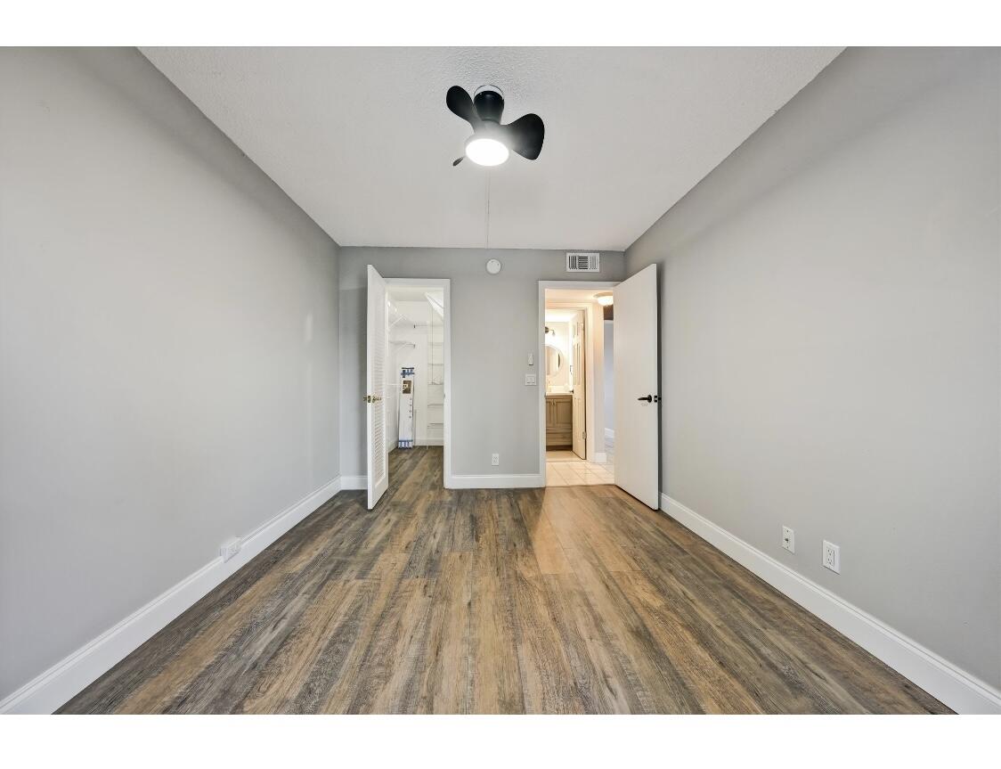 209 Northampton K, Unit K West Palm Beach, FL 33417 - Photo 9 of 24 a view of an empty room with glass door