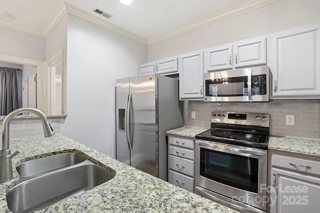 a kitchen with a sink stove and refrigerator