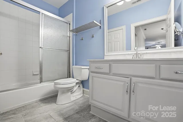 a bathroom with a toilet sink and shower