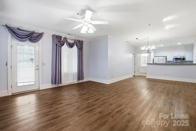 a view of a kitchen with a dishwasher and wooden floor