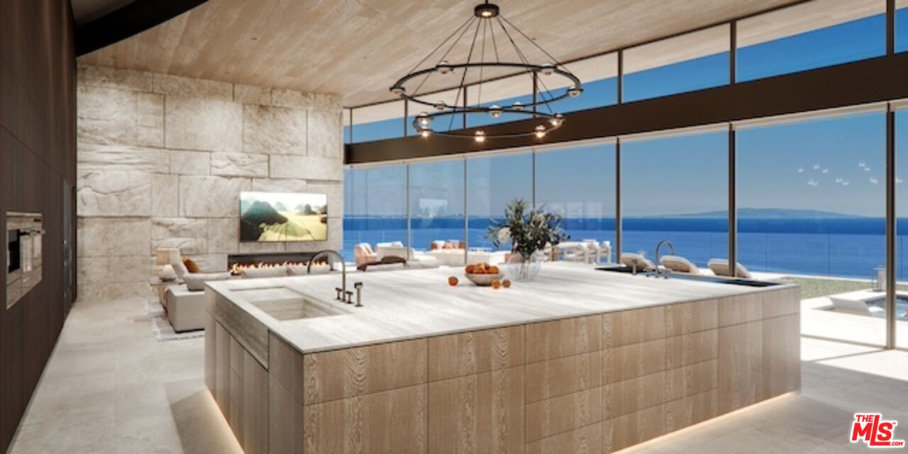 5024 Carbon Beach Terrace Malibu, CA 90265 - Photo 16 of 35 a kitchen with a sink a counter and chairs